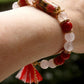 Bracelet poétique rouge, rose et or avec pompon japonisant de la marque Charmantissime