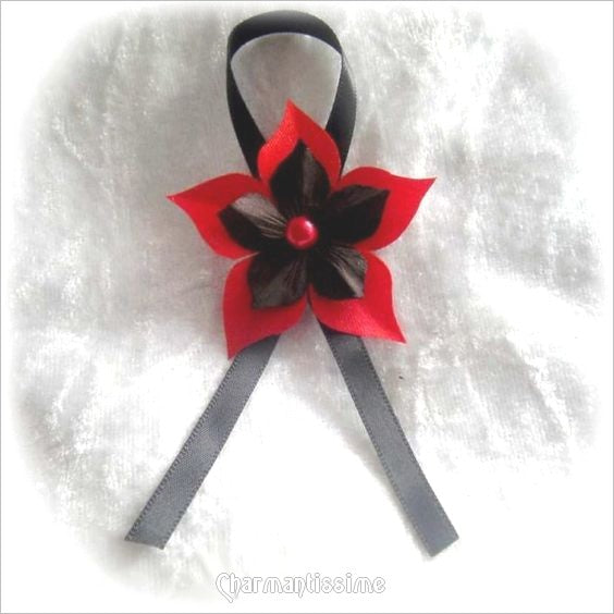 Cocarde boutonnière ruban et fleur étoile rouge et noir pour mariage et fête