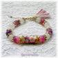 bracelet japonais fleurs de cerisier sakura avec pierres roses boho-chic et pompon rose fushia et or